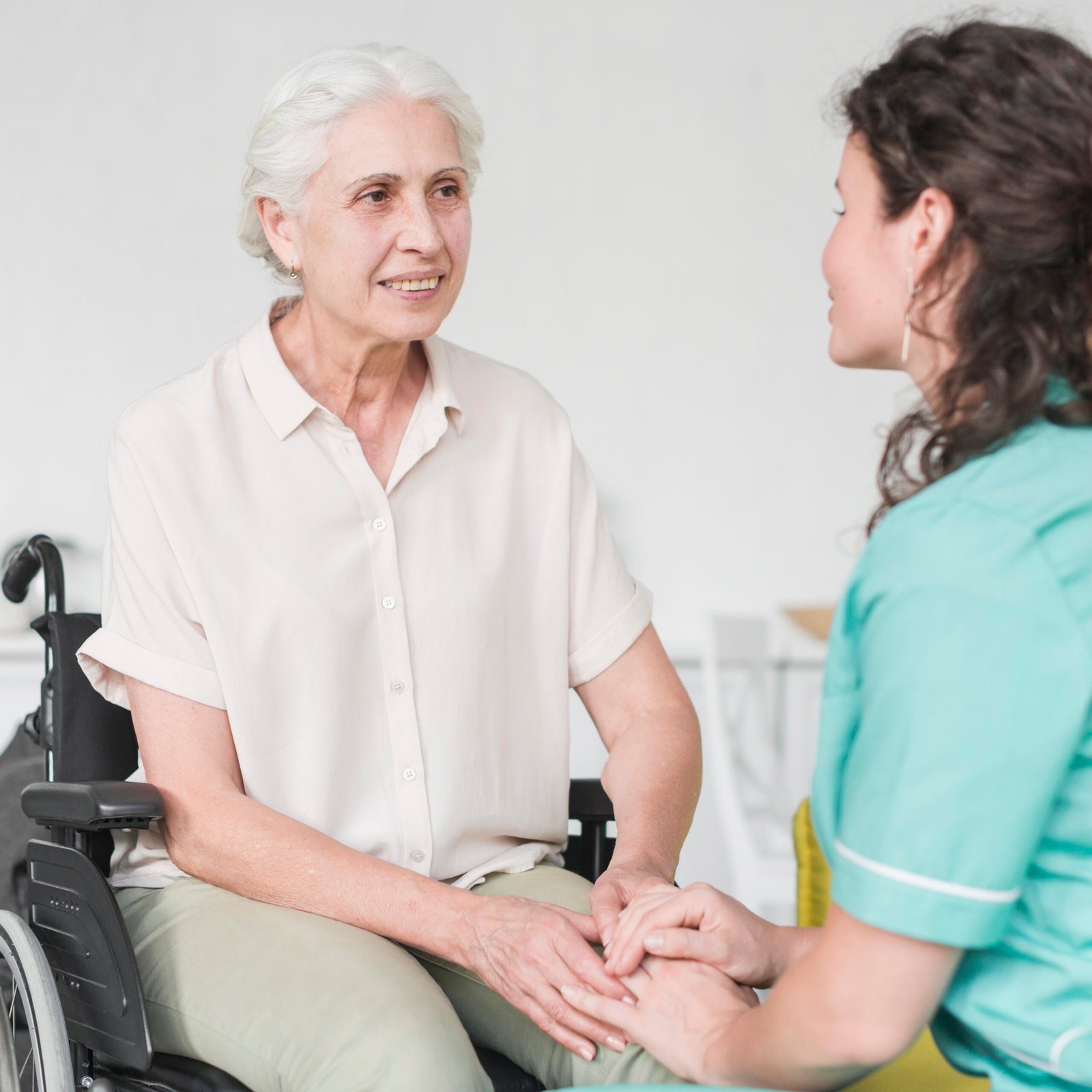 happy-disabled-nurse-sitting-wheel-chair-looking-caretaker